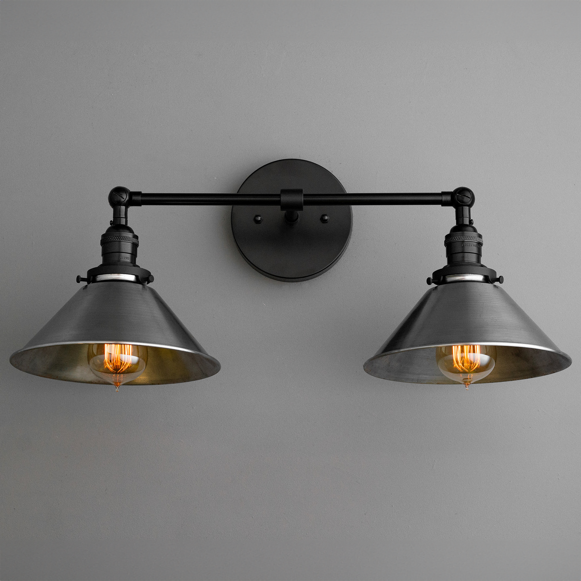 Two-bulb black industrial vanity light with conical metal shades and exposed filament bulbs. - VANITY LIGHT MODEL NO. 0799