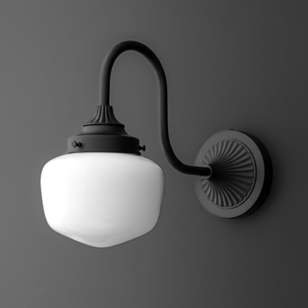 Black metal wall sconce with curved arm and frosted white glass globe shade. - SCONCE MODEL NO. 1061