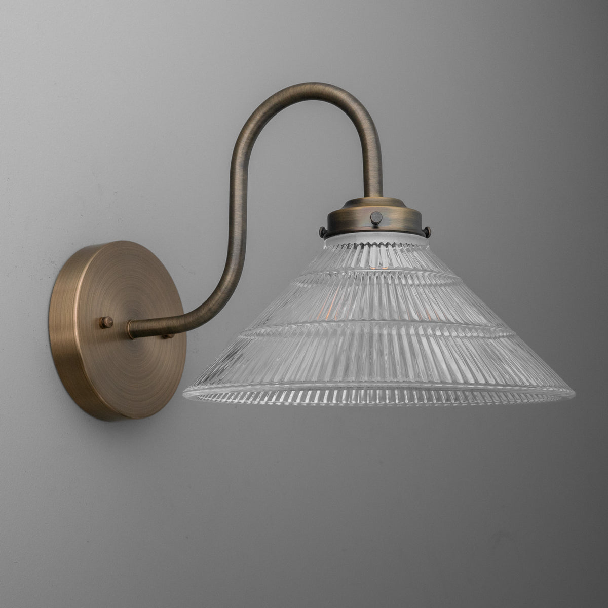Brushed bronze 1-bulb wall sconce with curved arm and ribbed clear glass shade. - SCONCE MODEL NO. 6263