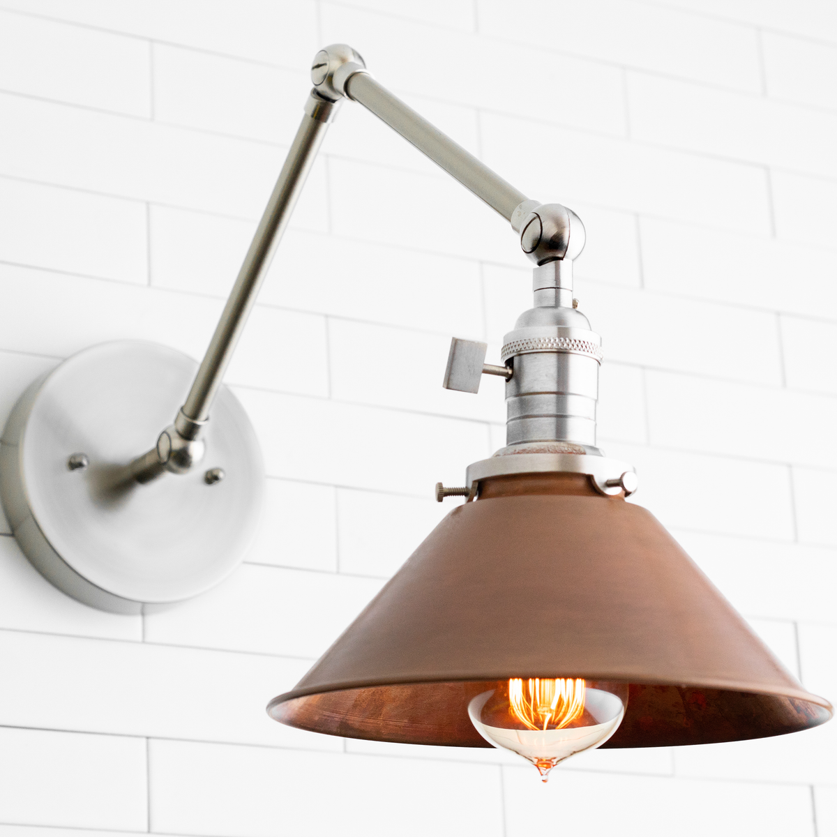 Adjustable wall sconce with brushed nickel arm and copper-tone conical shade over Edison bulb. - SCONCE MODEL NO. 6668