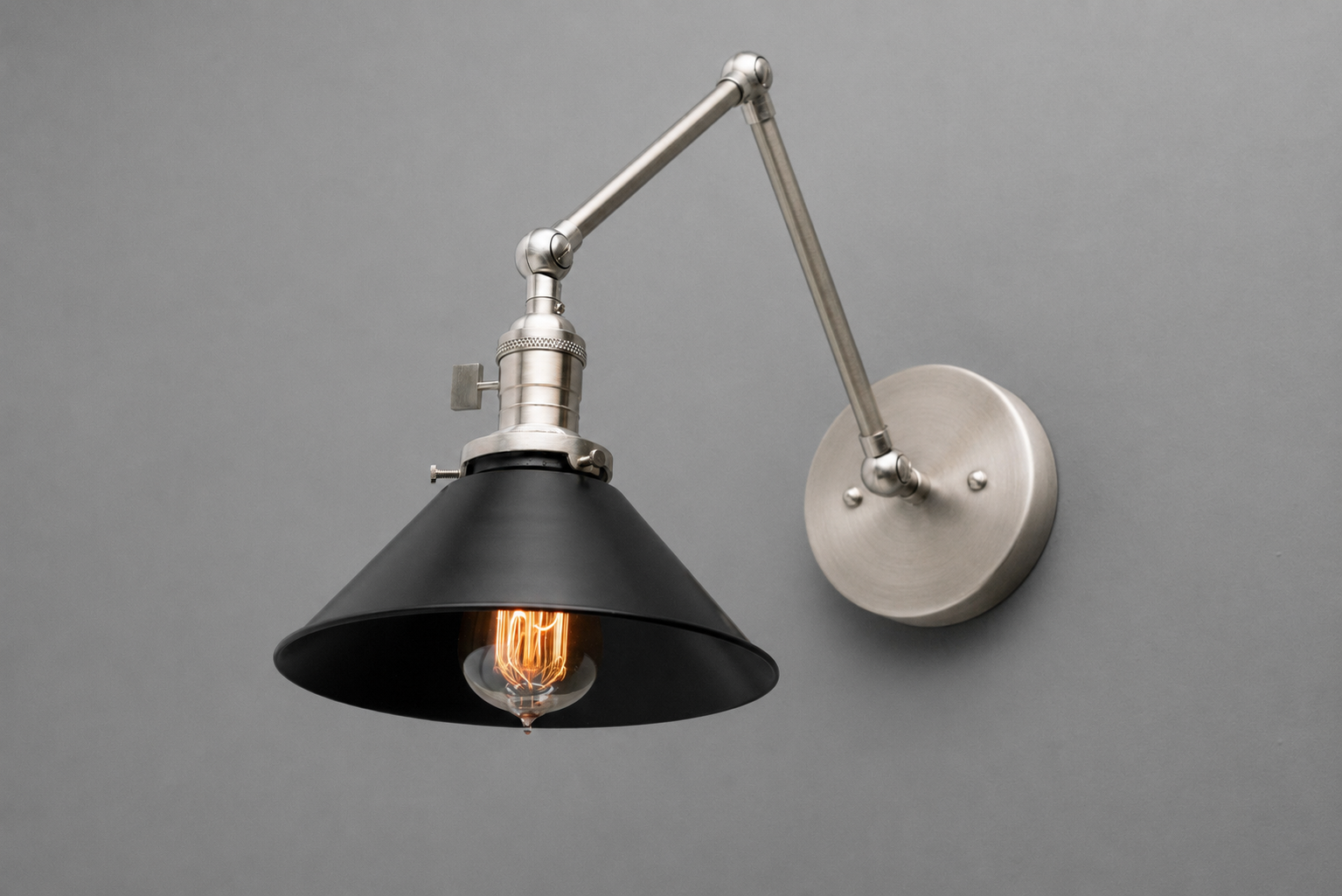 Industrial-style adjustable wall sconce with matte black conical metal shade and brushed nickel arm. - SCONCE MODEL NO. 7164