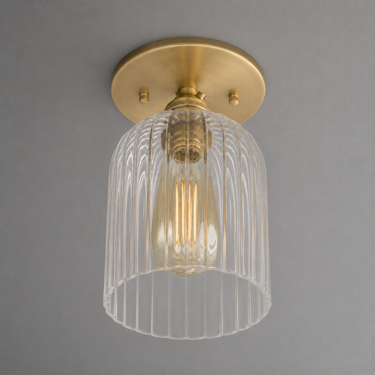 Single-light ceiling light in Raw or Sealed Brass with a ribbed glass bell shade around an exposed bulb, mounted on a round canopy. - CEILING LIGHT MODEL NO. 1116