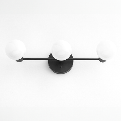 Mid-century modern 3-bulb black vanity light with round white glass shades and matte black metal frame. - VANITY LIGHT MODEL NO. 0518
