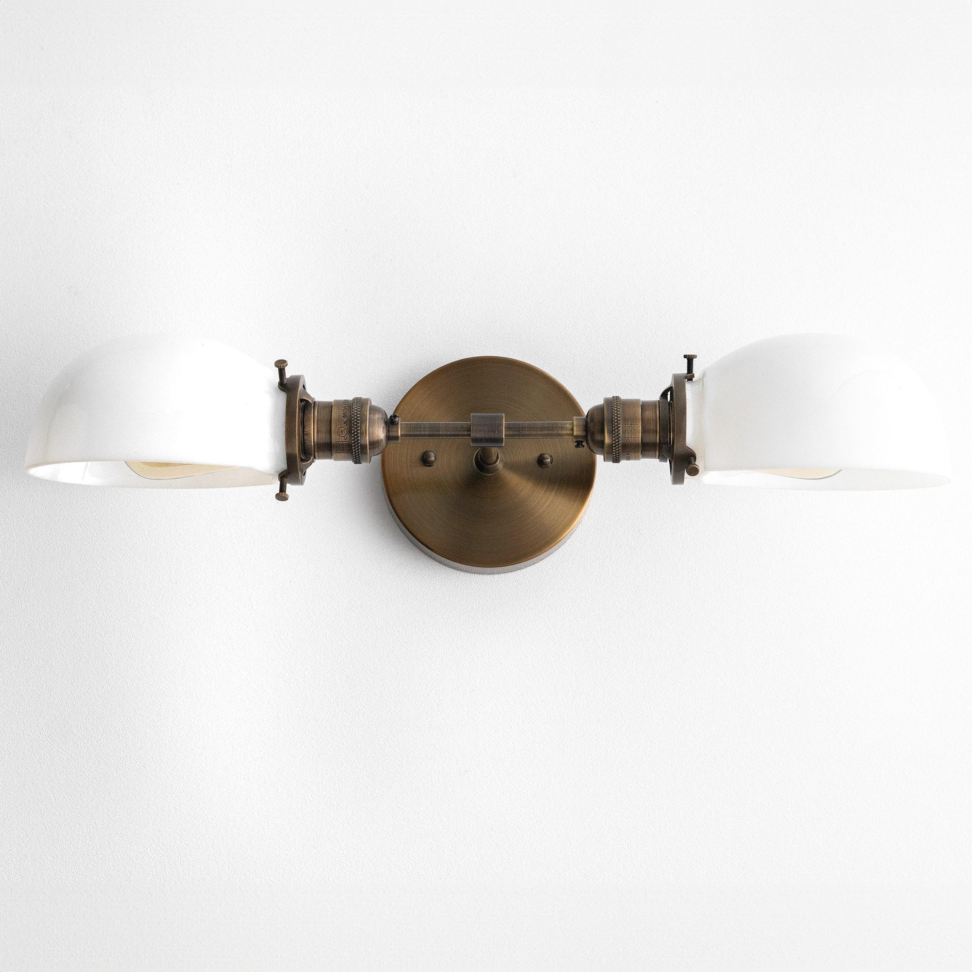 Mid-century modern two-bulb vanity light with antique brass finish and white glass shades. - VANITY LIGHT MODEL NO. 1734