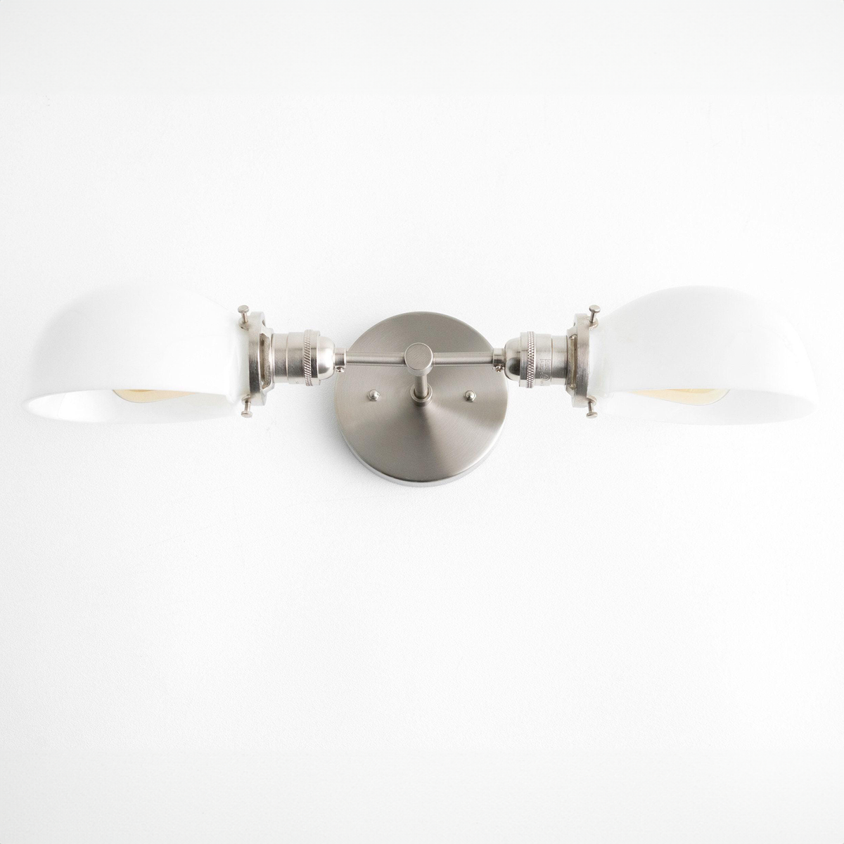 Mid-century modern two-bulb vanity light with brushed nickel finish and white curved shades. - VANITY LIGHT MODEL NO. 1734