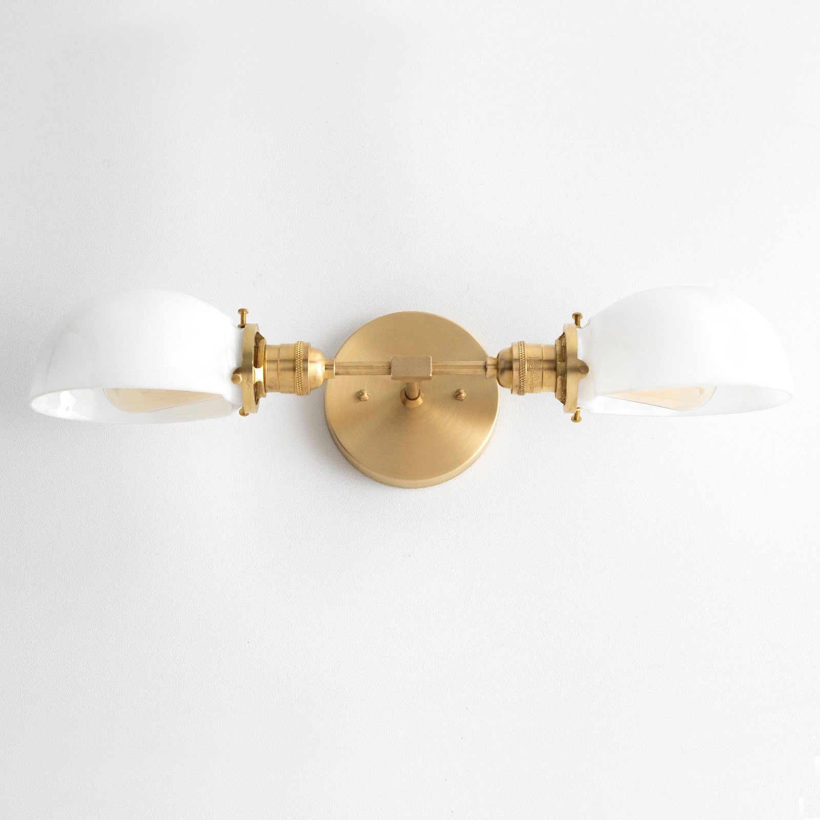 Mid-century modern two-bulb vanity light with antique brass finish and white glass shades. - VANITY LIGHT MODEL NO. 1734