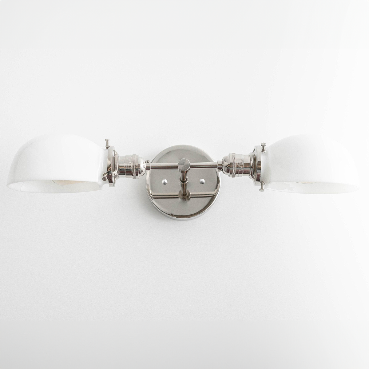 Mid-century modern two-bulb vanity light in polished nickel with white curved shades and round wall mount. - VANITY LIGHT MODEL NO. 1734