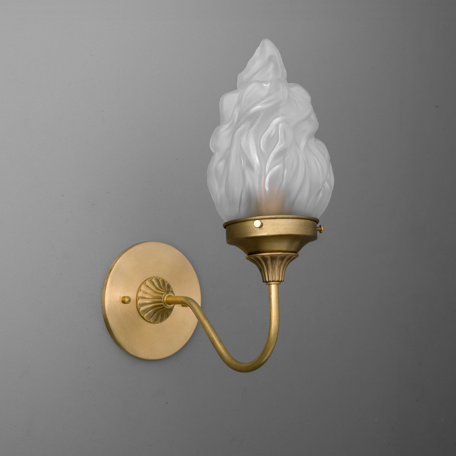 Brushed brass wall sconce with curved arm and white frosted glass flame-shaped shade. - SCONCE MODEL NO. 1024