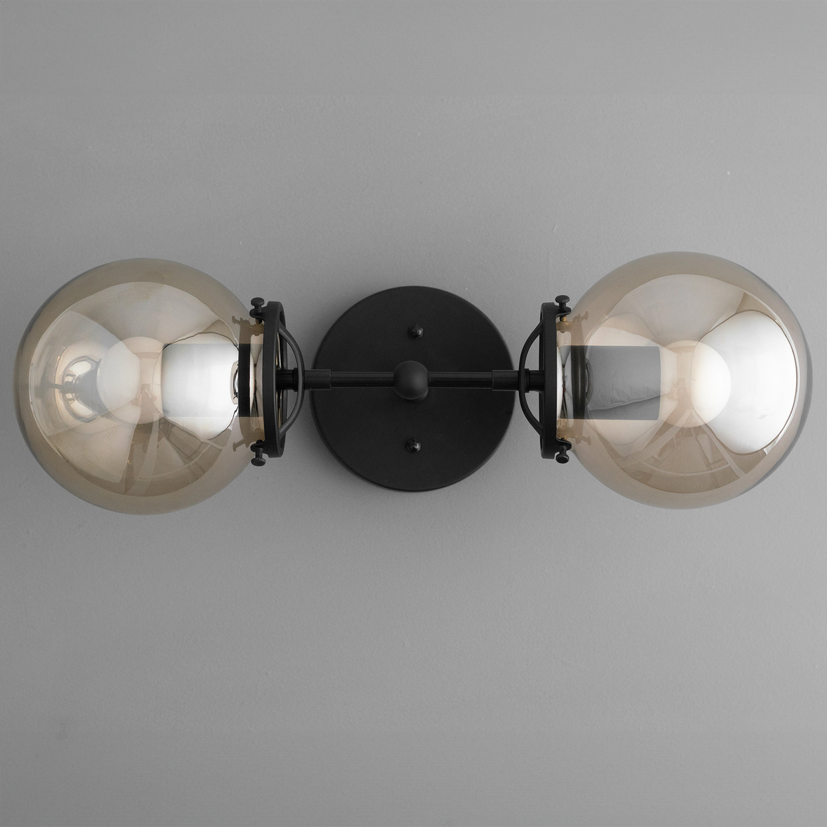 Black industrial vanity light with two large amber glass globe bulbs and round wall mount. - VANITY LIGHT MODEL NO. 8983