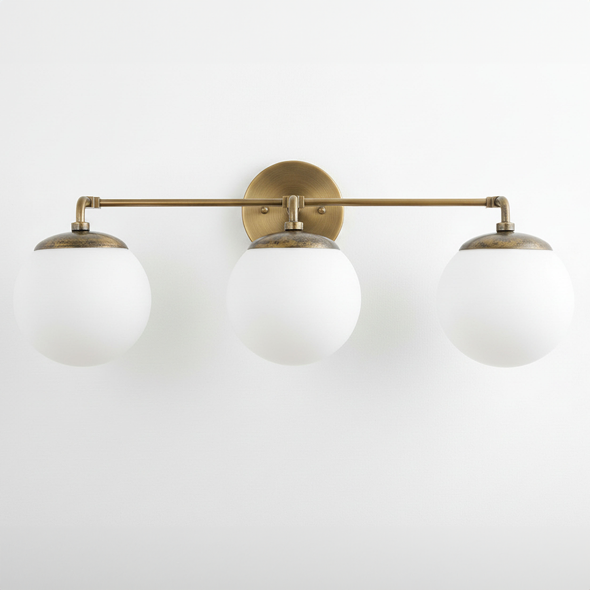 Mid-century modern vanity light with three white globe bulbs and raw brass finish. - VANITY LIGHT MODEL NO. 9319