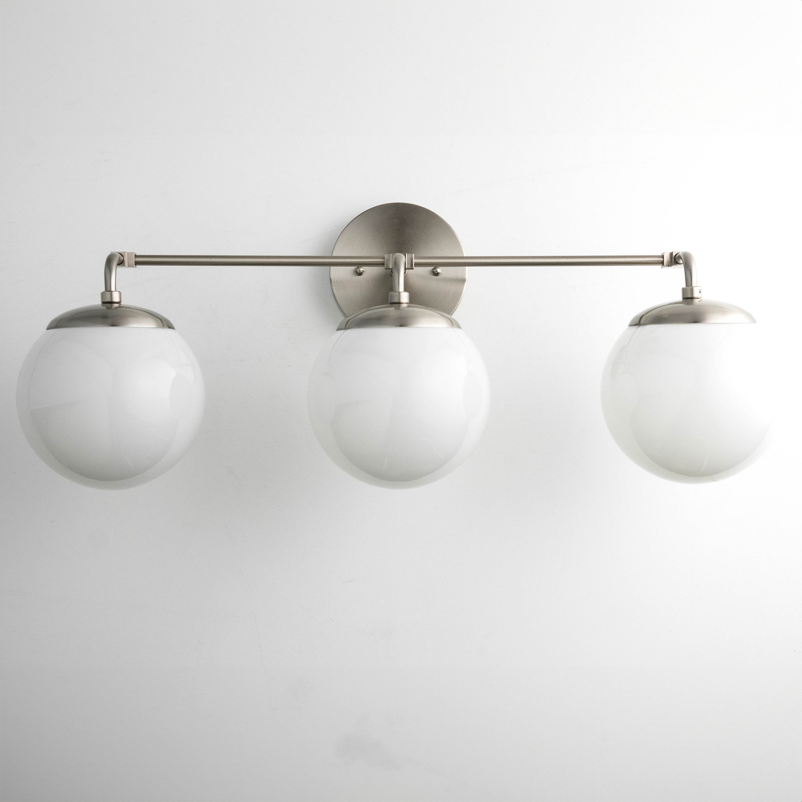 Three-globe vanity light fixture with brushed nickel finish and white frosted glass globes. - VANITY LIGHT MODEL NO. 9319