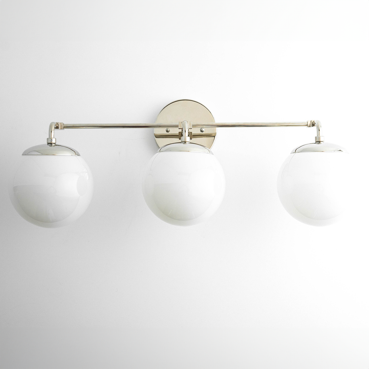 Mid-century modern vanity light with three white glass globe shades and a satin nickel horizontal bar. - VANITY LIGHT MODEL NO. 9319