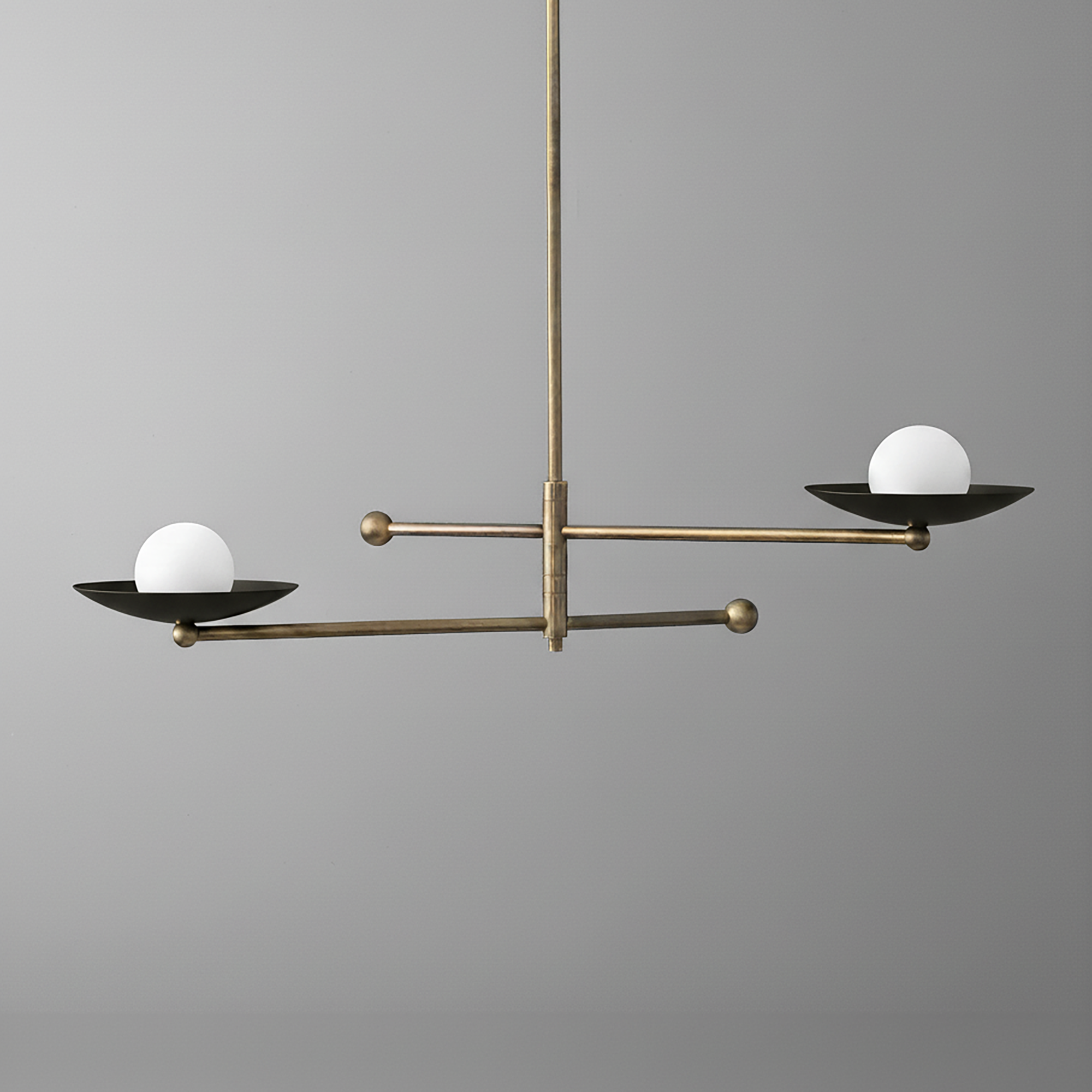 Mid-century modern chandelier with antique brass arms and two black metal dishes holding white globe bulbs. - CHANDELIER MODEL NO. 2933