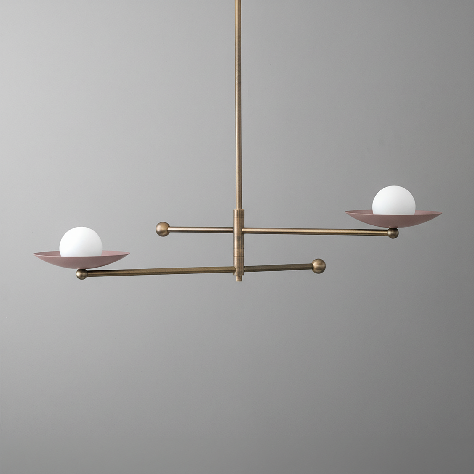 Antique brass chandelier with two mauve metal arms, each holding a white globe light. - CHANDELIER MODEL NO. 2933