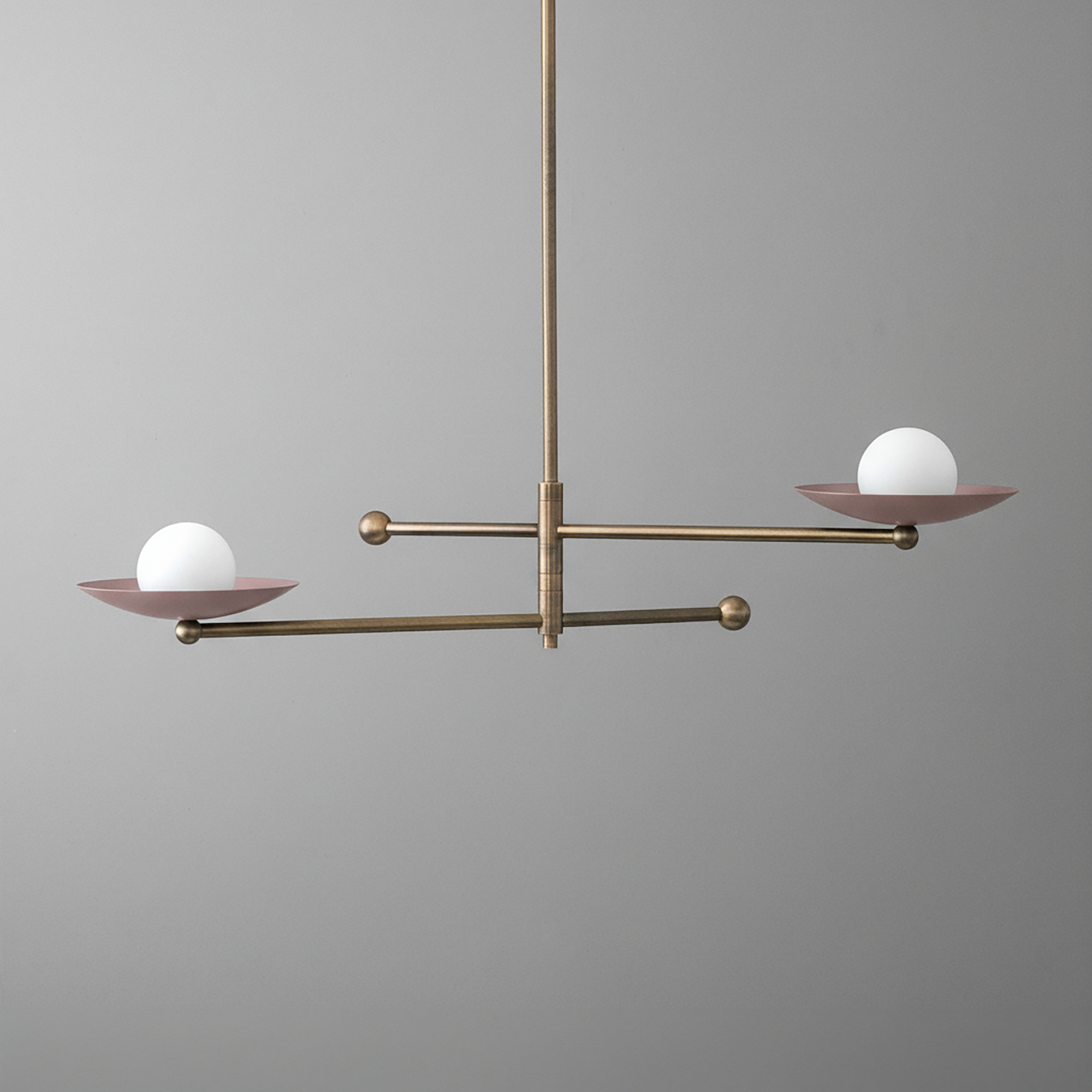 Antique brass chandelier with two mauve metal arms, each holding a white globe light. - CHANDELIER MODEL NO. 2933