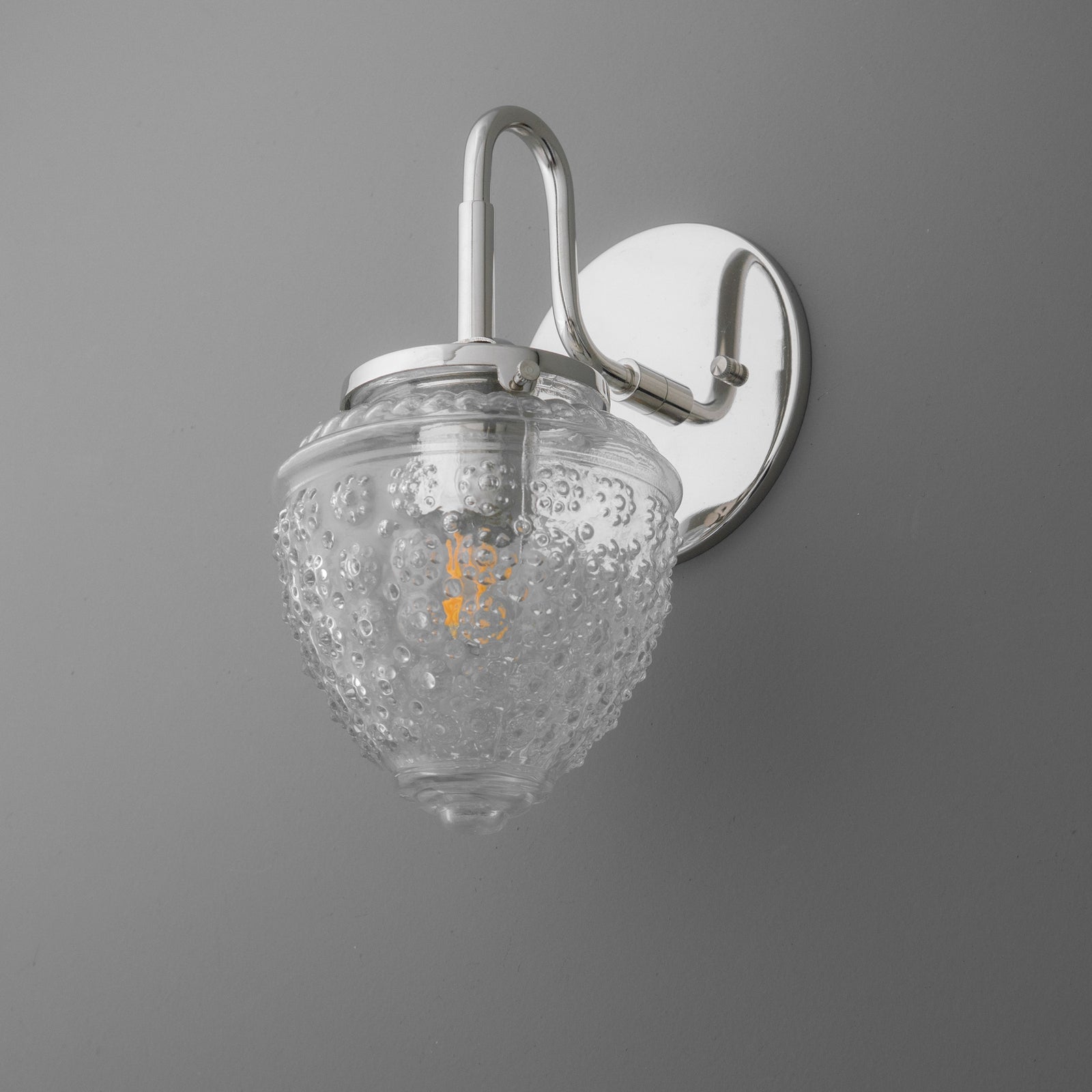 Wall-mounted single-bulb sconce with polished chrome finish and textured clear glass shade. - SCONCE MODEL NO. 1037