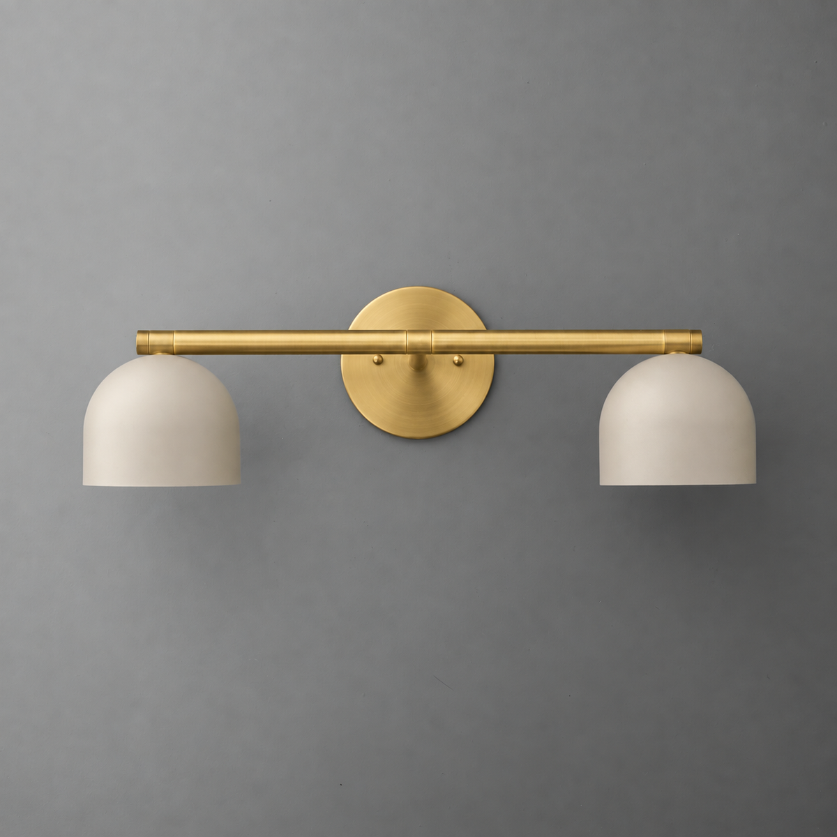 Two-light vanity light in Raw or Sealed Brass with Cream steel dome shades hanging from a straight bar on a round wall plate. - VANITY LIGHT MODEL NO. 1186