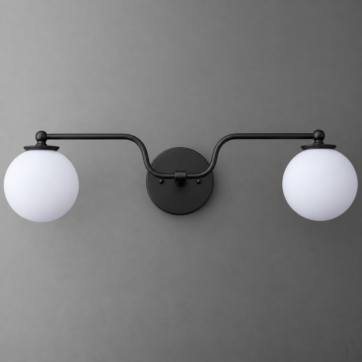 Black metal vanity light with two round white glass globes on curved arms. - VANITY LIGHT MODEL NO. 1153