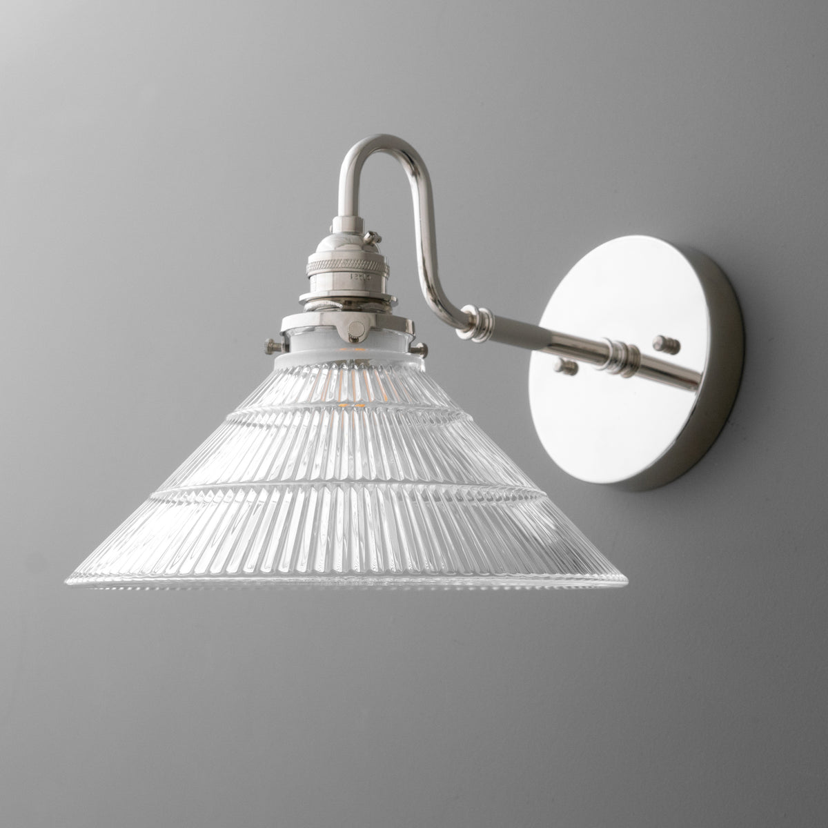Wall-mounted metal sconce with curved arm and clear ribbed glass conical shade. - SCONCE MODEL NO. 4703