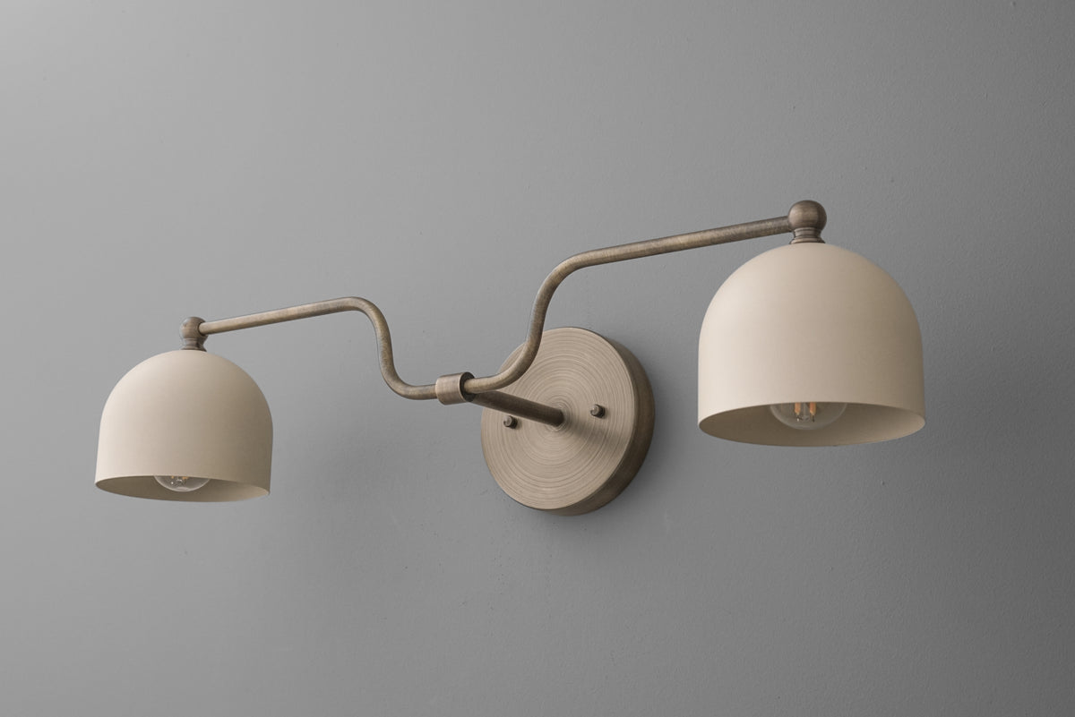 Brushed nickel double-arm vanity light with two dome-shaped white glass shades mounted on a round metal base. - VANITY LIGHT MODEL NO. 1157