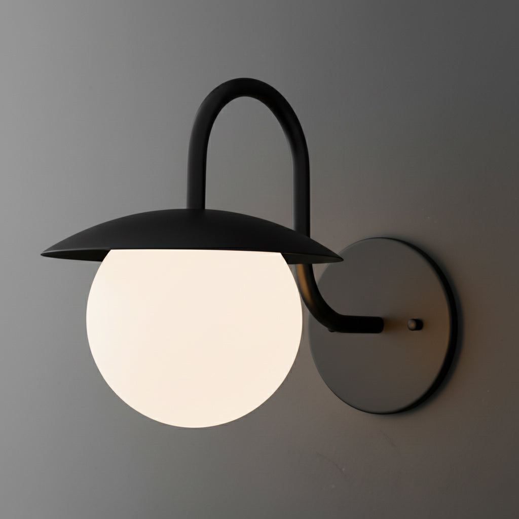 Black metal wall sconce with curved arm and frosted white glass globe shade. - SCONCE MODEL NO. 2206