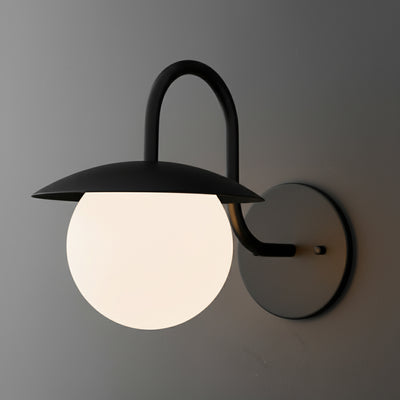 Black metal wall sconce with curved arm and frosted white glass globe shade. - SCONCE MODEL NO. 2206