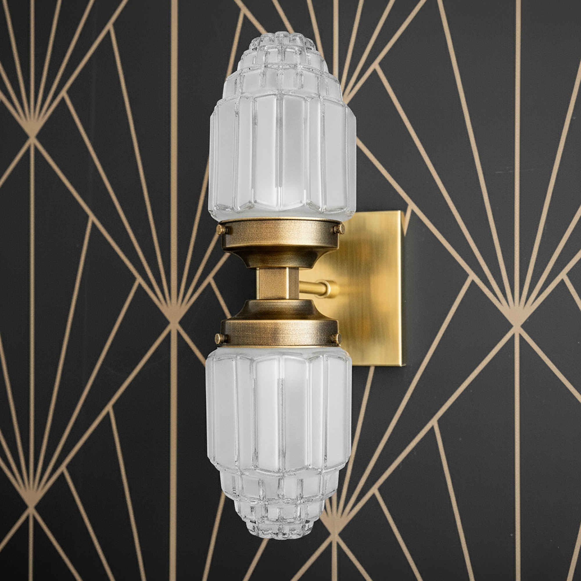 Art Deco style wall sconce with raw brass finish and two vertically stacked frosted glass globes with textured detailing. - SCONCE MODEL NO. 7180