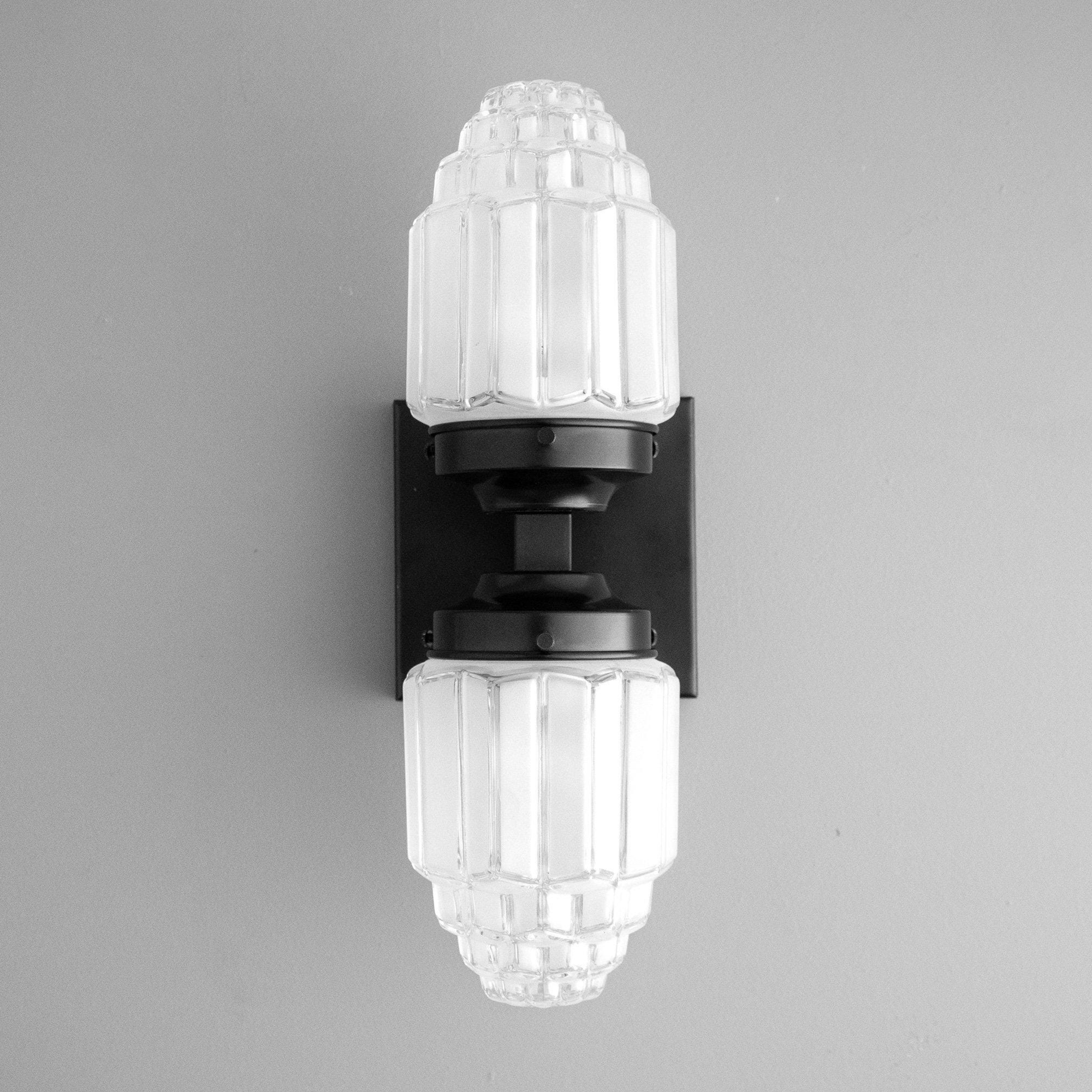 Art Deco black wall sconce with ribbed glass globes and semi-flush mount design. - SCONCE MODEL NO. 7180