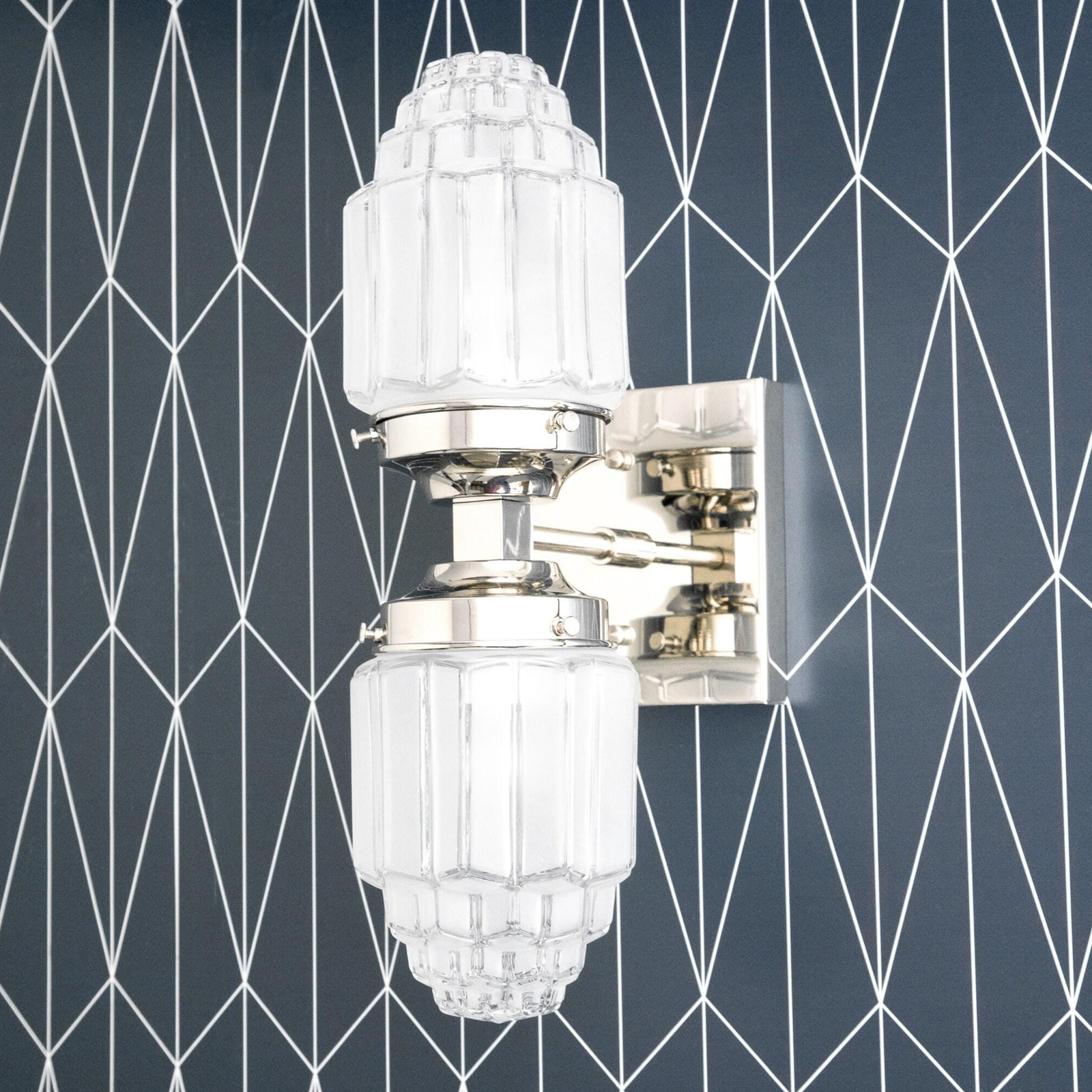 Polished nickel Art Deco wall sconce with two ribbed glass globes and geometric mounting plate. - SCONCE MODEL NO. 7180