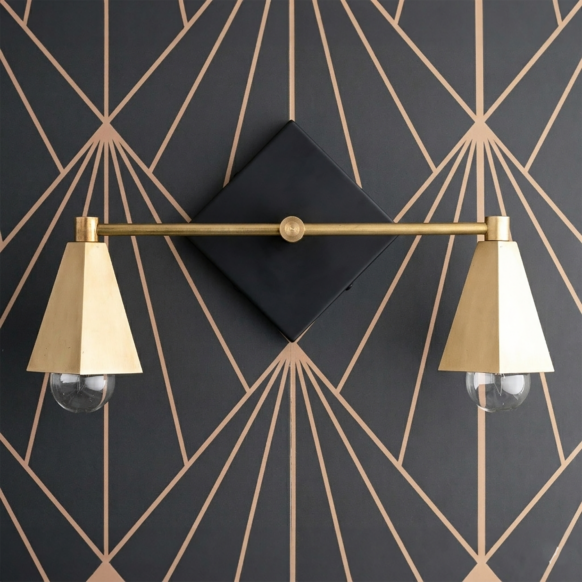 Art Deco style vanity light with two brass cone-shaped shades and exposed bulbs on a black diamond backplate. - VANITY LIGHT MODEL NO. 4237