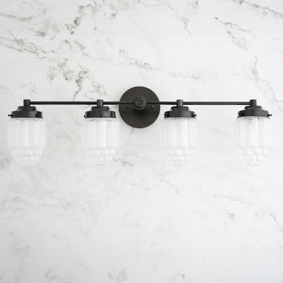 4-bulb black metal vanity light with frosted ribbed glass globe shades on marble wall. - VANITY LIGHT MODEL NO. 1082