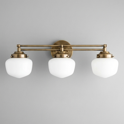 Three-bulb vanity light with antique brass finish and white globe shades in Art Deco style. - VANITY LIGHT MODEL NO. 4352