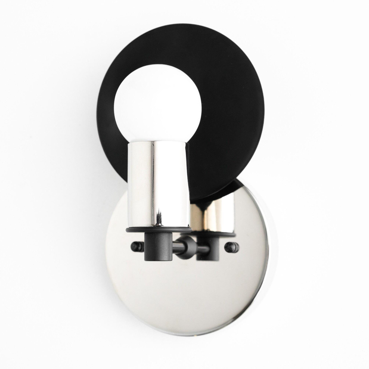 Polished nickel and black Art Deco wall sconce with exposed round bulb and circular backplate. - SCONCE MODEL NO. 8677