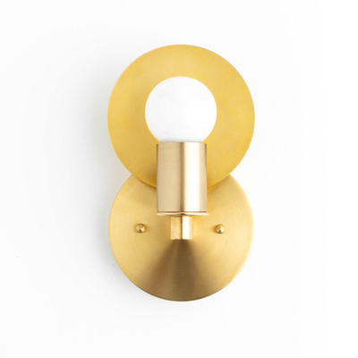 Raw brass Art Deco wall sconce with round backplate and bare bulb design. - SCONCE MODEL NO. 8677