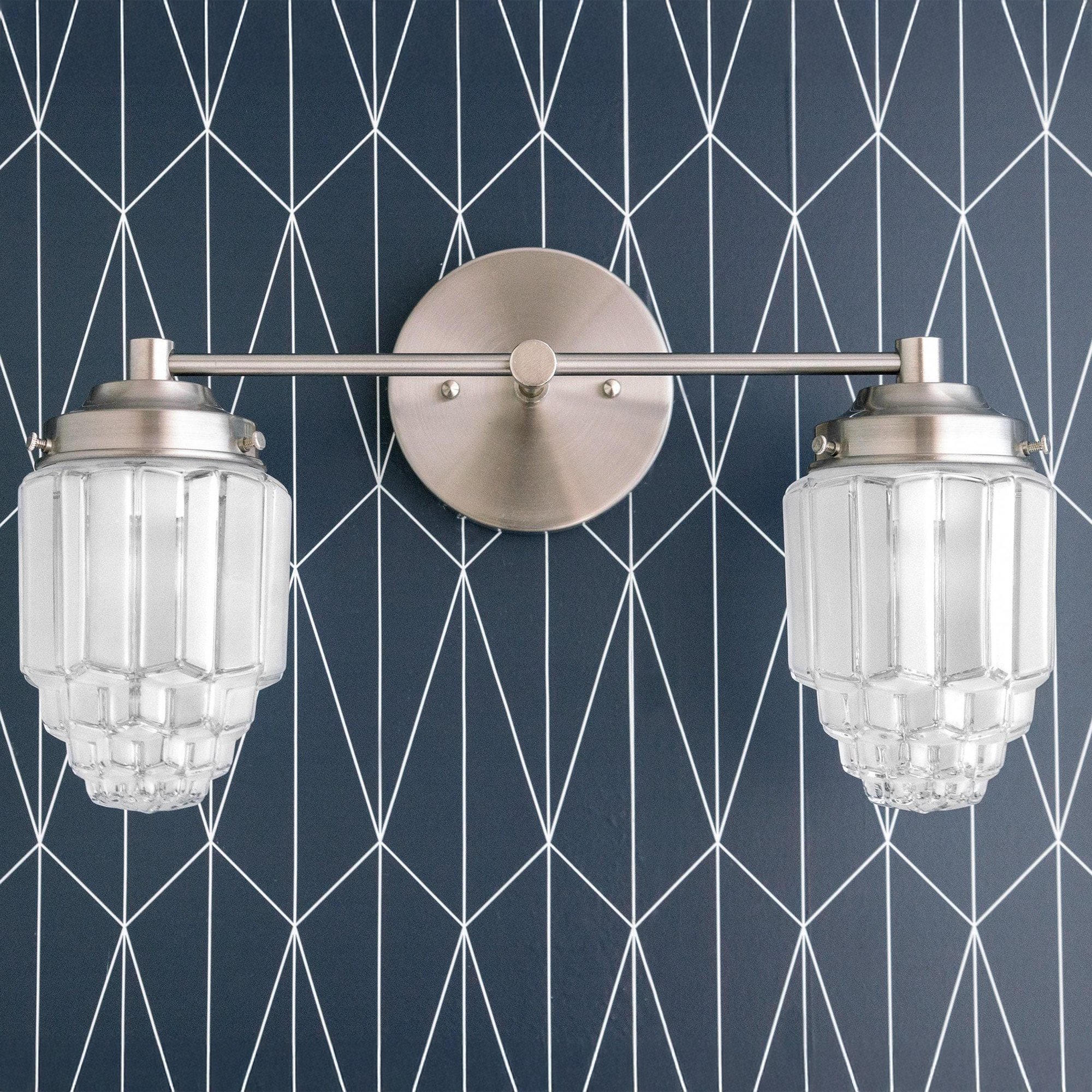 Brushed nickel vanity light with two art deco glass globe shades on geometric navy wall. - VANITY LIGHT MODEL NO. 9777