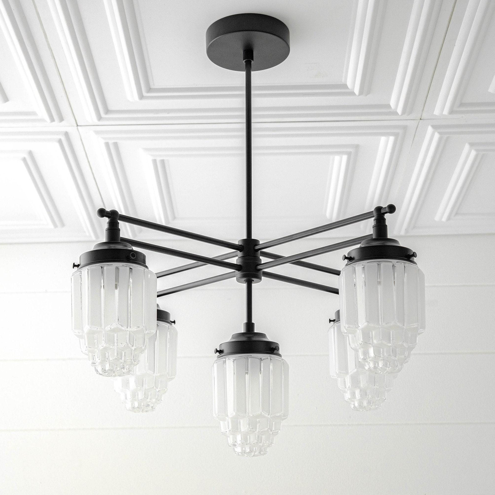Black Art Deco chandelier with five tiered globe glass shades and a matte black metal frame. - CHANDELIER MODEL NO. 5830
