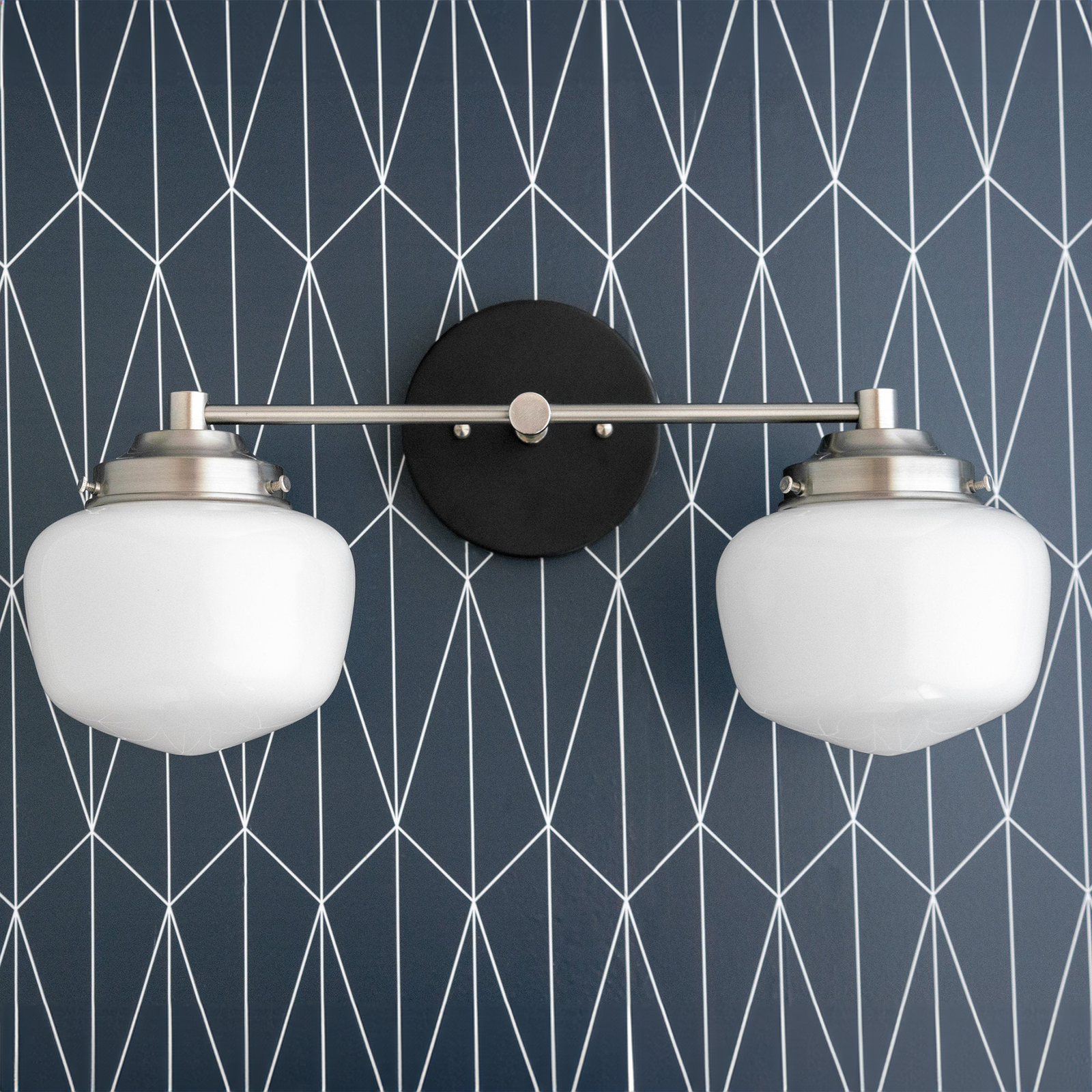 Two-bulb bathroom vanity light with brushed nickel finish and white globe shades on black mounting plate. - VANITY LIGHT MODEL NO. 5799