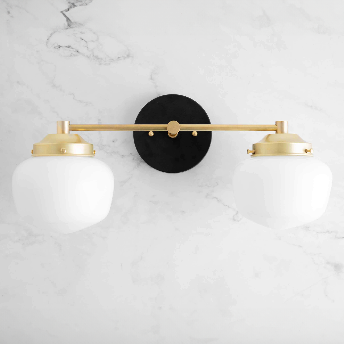 Two-bulb vanity light with sealed brass finish and white globe shades on round black wall mount. - VANITY LIGHT MODEL NO. 5799