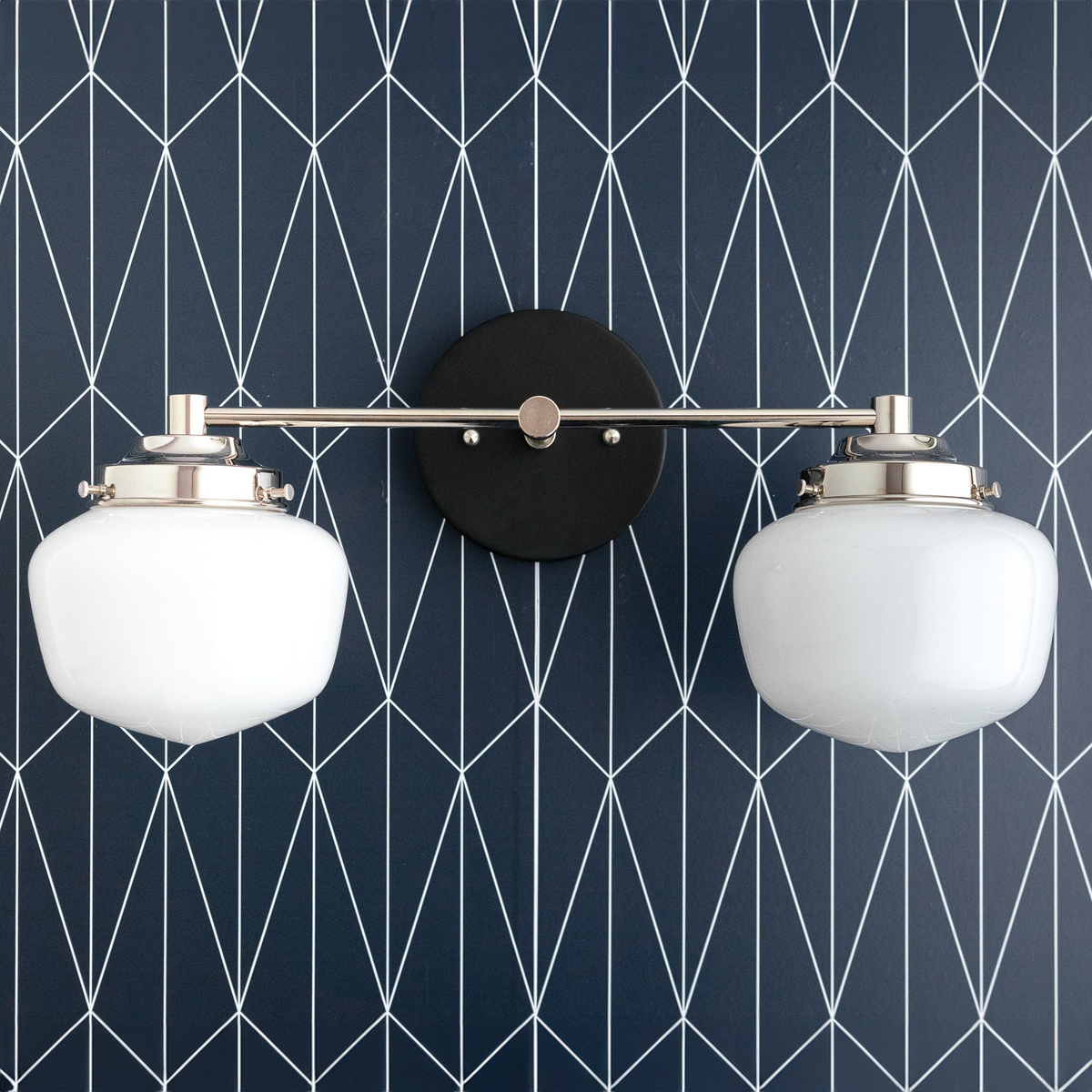 Two-bulb vanity light with polished nickel arms and round white globe shades on black circular mount. - VANITY LIGHT MODEL NO. 5799