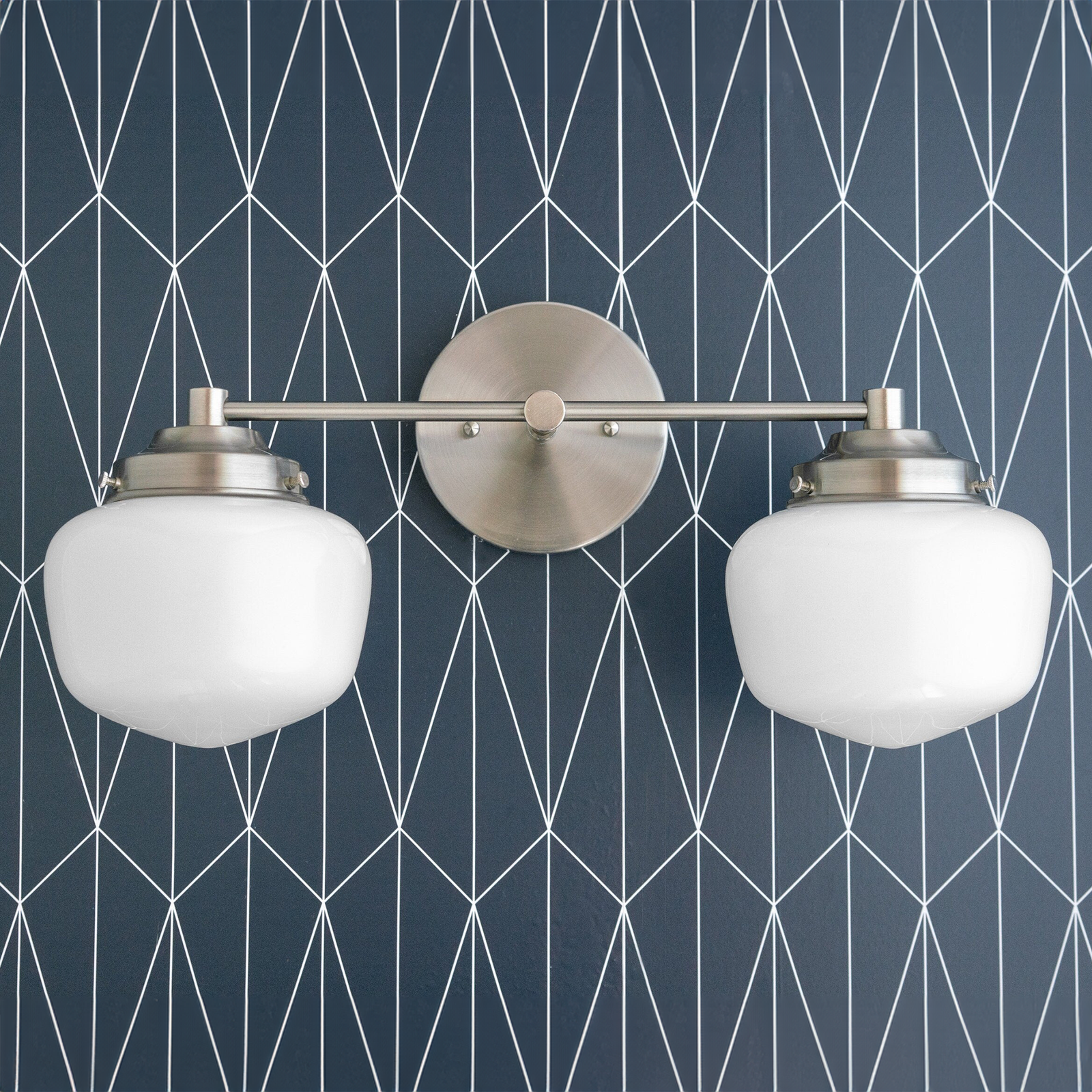 Two-bulb vanity light with polished nickel finish and white globe shades mounted on geometric blue wall. - VANITY LIGHT MODEL NO. 5799