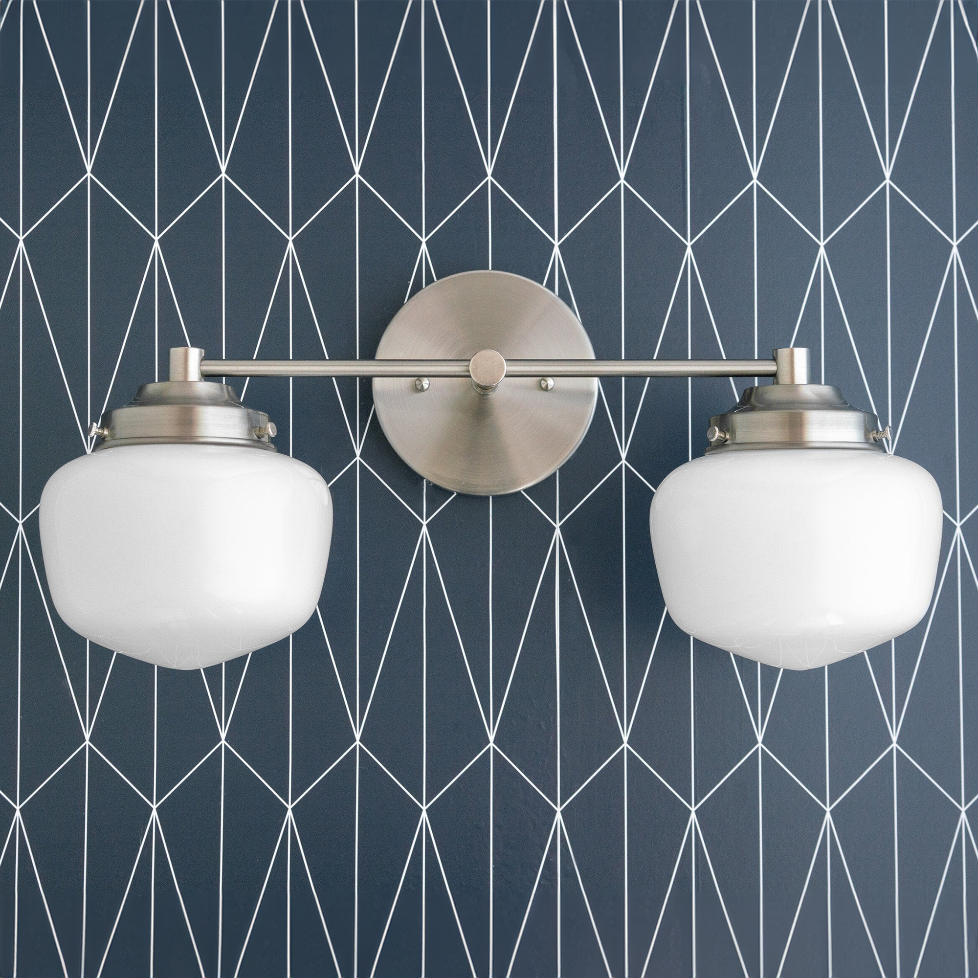 Art Deco two-bulb vanity light with polished nickel finish and white globe shades on geometric blue wall. - VANITY LIGHT MODEL NO. 5799