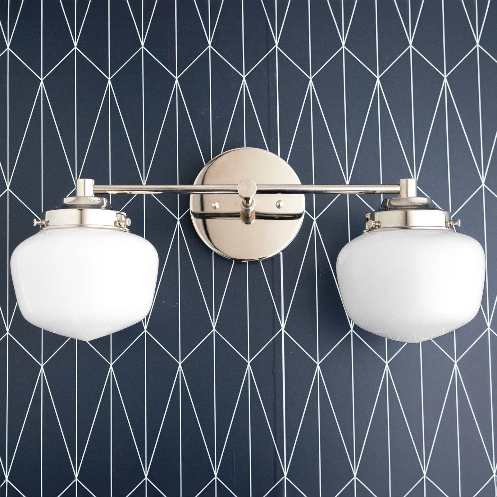 Art Deco two-bulb vanity light with brushed nickel finish and white globe shades against geometric navy wallpaper. - VANITY LIGHT MODEL NO. 5799