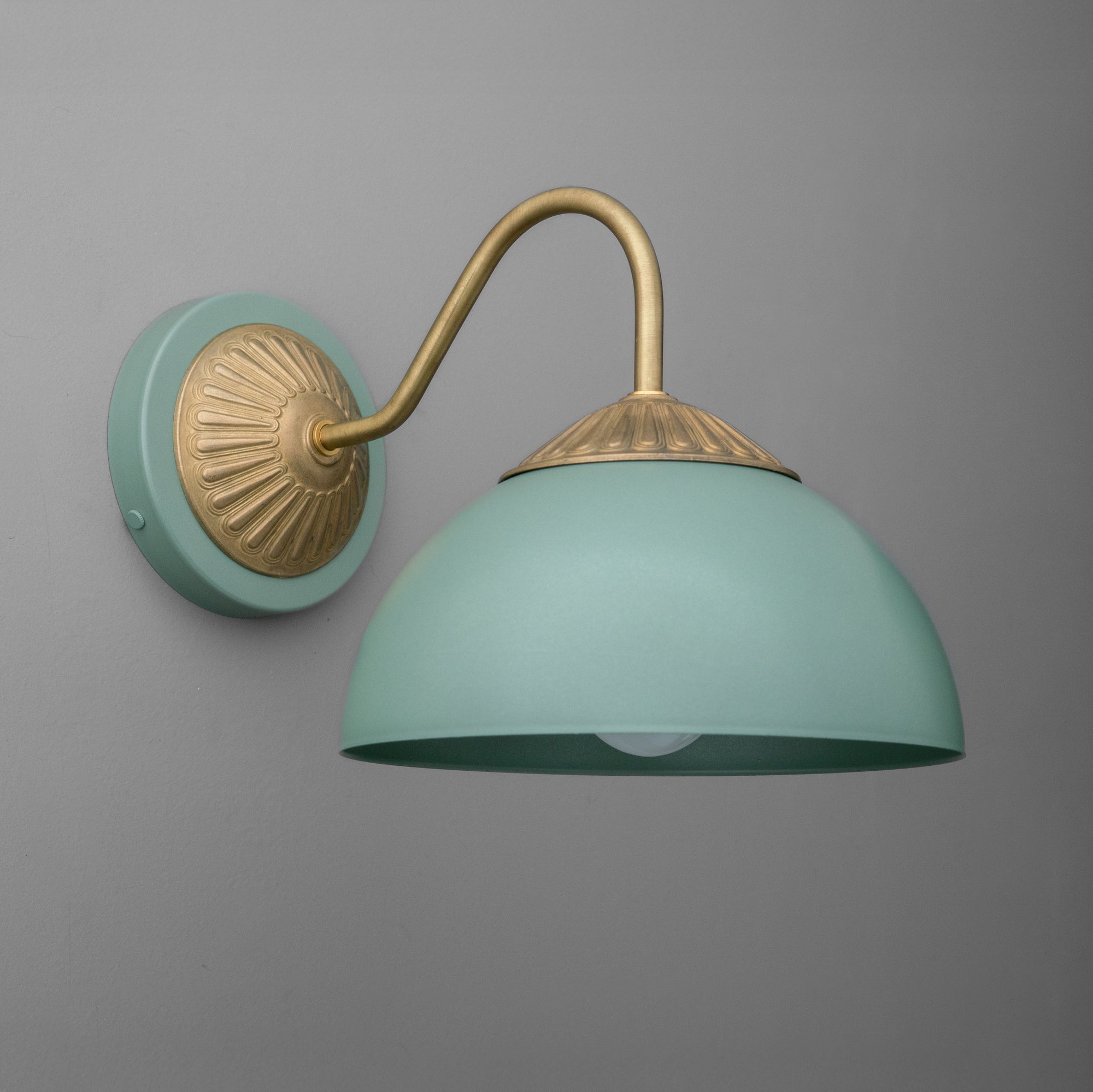 Raw brass wall sconce with a curved arm and a matte periwinkle blue dome shade. - SCONCE MODEL NO. 9408