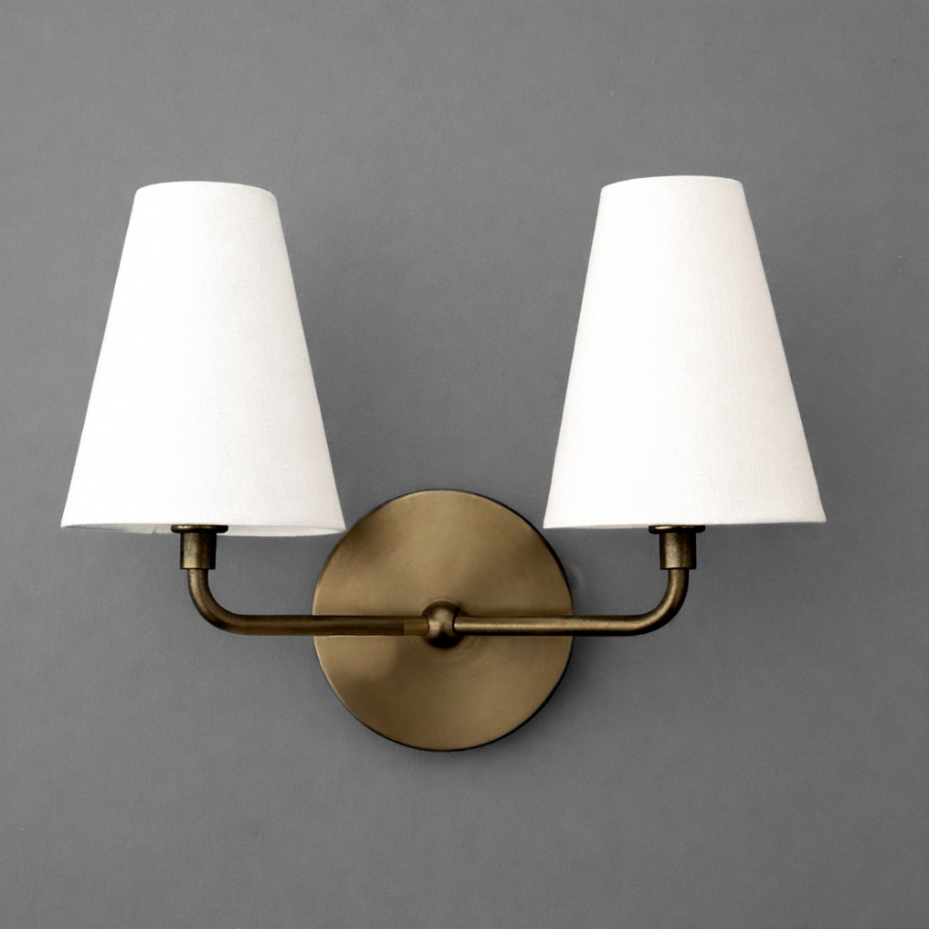 Two-bulb wall sconce with antique brass finish and white tapered fabric shades. - SCONCE MODEL NO. 0823