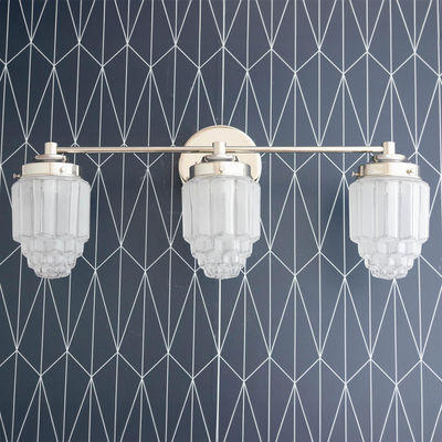 Three-bulb vanity light with polished nickel finish and textured glass globe shades against geometric wallpaper. - VANITY LIGHT MODEL NO. 3918