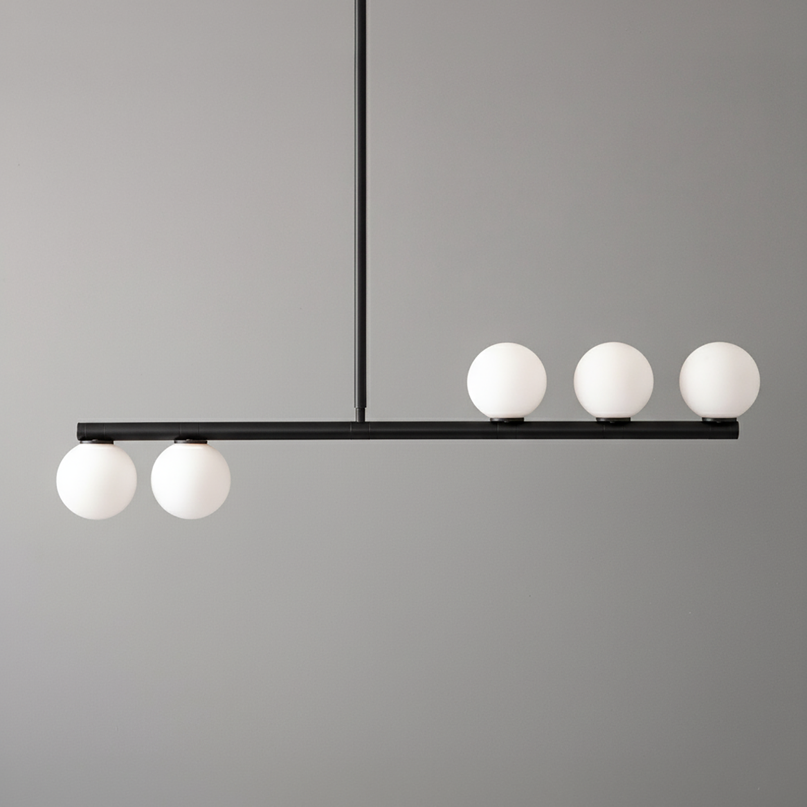 Minimalist black linear chandelier with five white globe lights in a balanced arrangement. - CHANDELIER MODEL NO. 6507