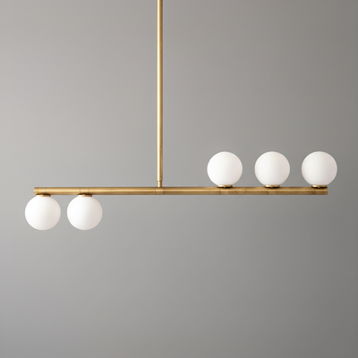 Linear brass chandelier with five white globe lights in a minimalist mid-century modern design. - CHANDELIER MODEL NO. 6507