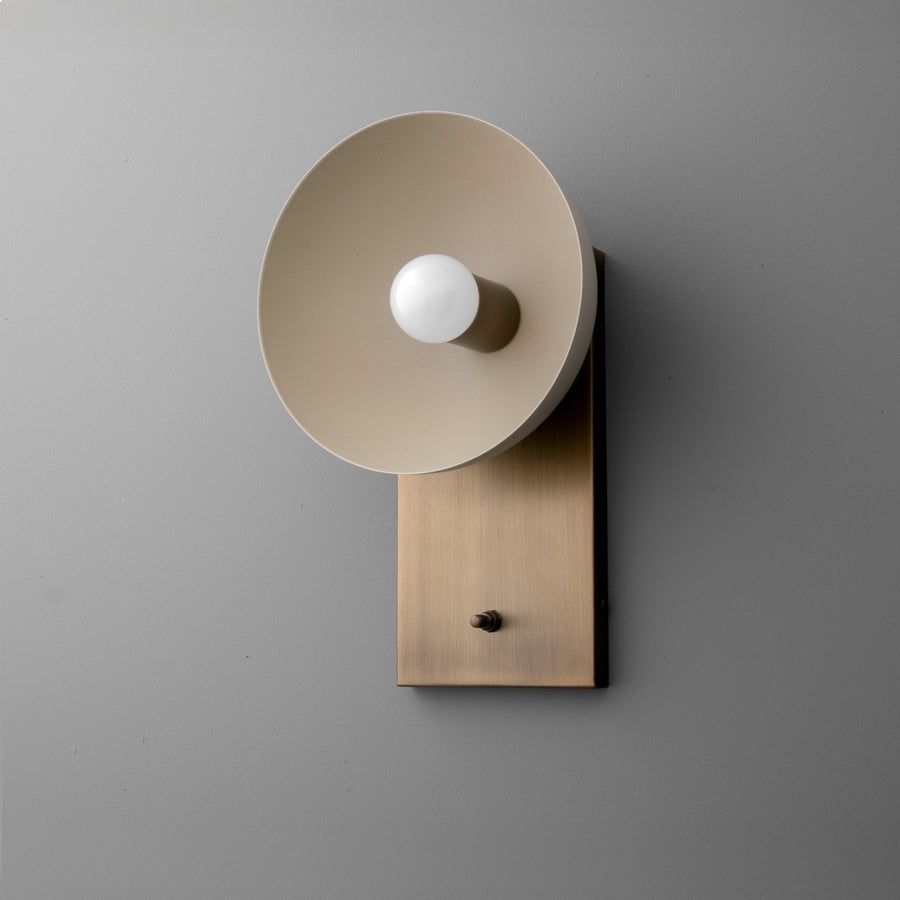 Antique brass wall sconce with wide dome-shaped cream shade and exposed bulb on rectangular base. - SCONCE MODEL NO. 3357
