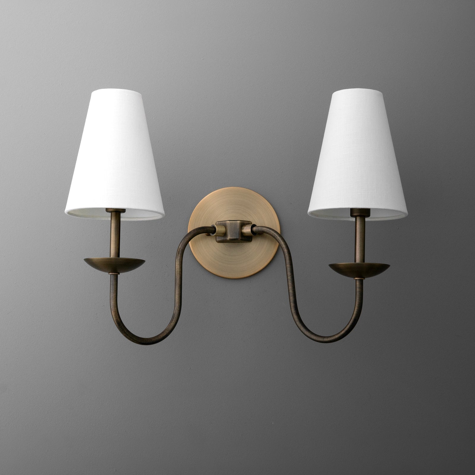Antique brass double-arm wall sconce with white tapered fabric shades. - SCONCE MODEL NO. 5846