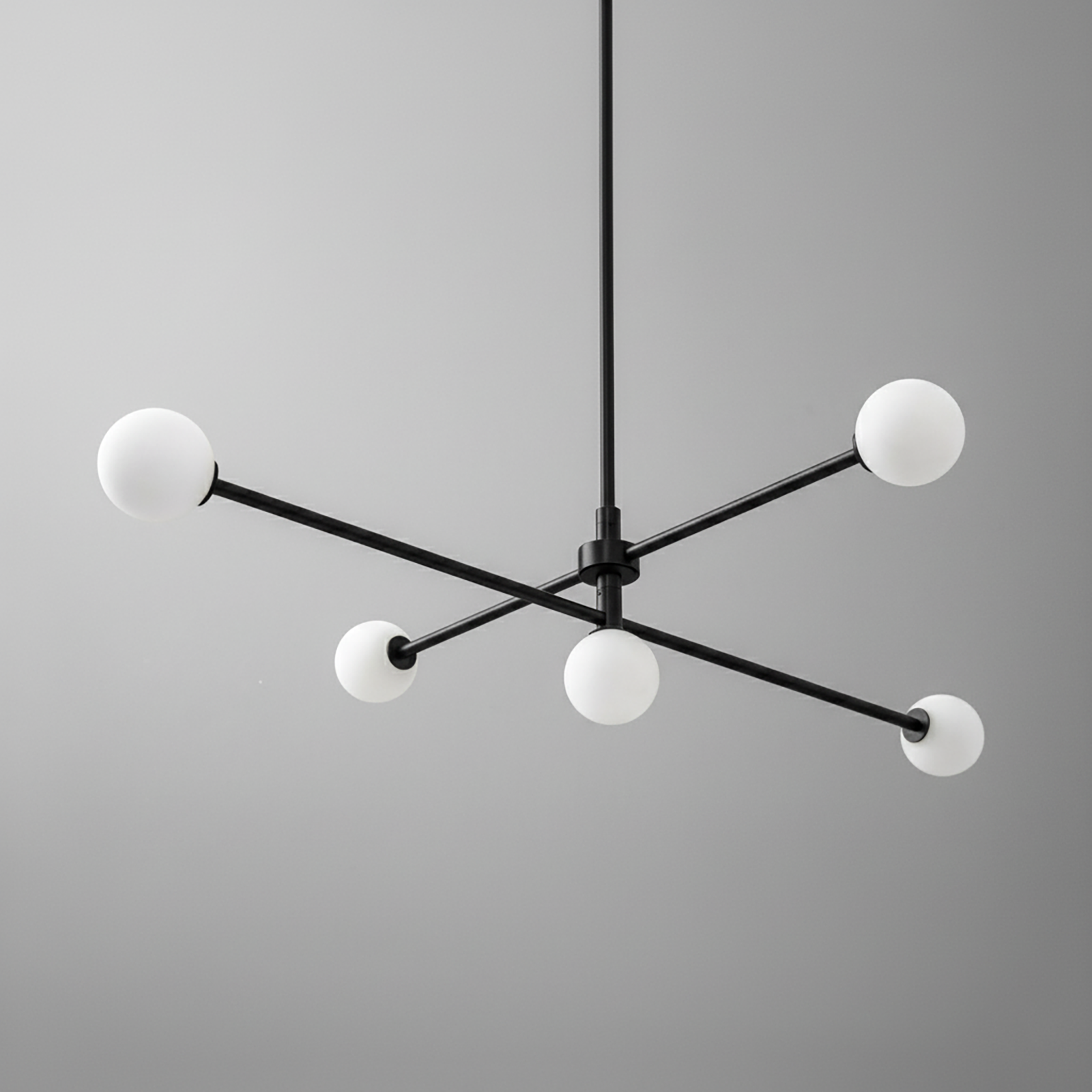 Mid-century modern black metal chandelier with four white globe bulbs on swivel arms. - CHANDELIER MODEL NO. 4577